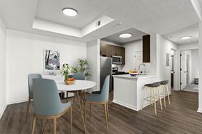 Atlanta apartment for rent - an open kitchen and dining room with a white table and chairs
