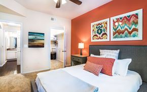 Dallas apartment for rent - a bedroom with a bed and a ceiling fan