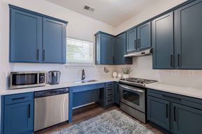 Knightdale apartment for rent - A kitchen with dark blue cabinets and stainless steel appliances.