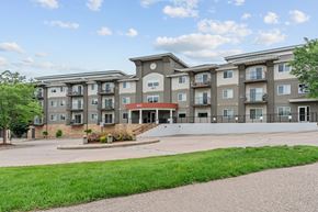 Chaska apartment for rent - Apartment building with a green lawn in front.