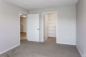 Chaska apartment for rent - an empty bedroom with a closet and an open door to the bathroom