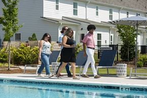 Conyers apartment for rent - A group of people are walking by a pool.