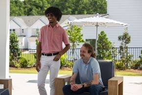 Conyers apartment for rent - Two men are sitting and standing in a sunny outdoor area.
