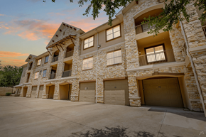 Grand Prairie apartment for rent - A large stone building with multiple garage doors.