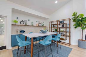 Winston Salem apartment for rent - A dining room with a white table and blue chairs.
