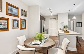 Charleston apartment for rent - A dining room with a table set for two and a laundry sign on the wall.