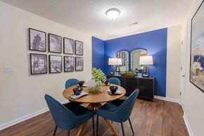 Fayetteville apartment for rent - A dining room with a wooden table and blue chairs.