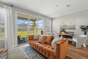 Jacksonville apartment for rent - A living room with a brown couch and a painting on the wall.