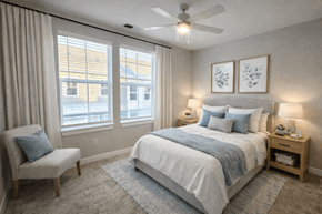 Zionsville apartment for rent - A bedroom with a bed, chair, and window.
