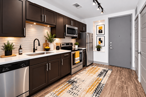 Plano apartment for rent - A kitchen with dark brown cabinets at Markethaus 3700 in Plano Texas