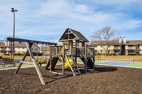 Taylors apartment for rent - A playground with a swing set and a yellow slide.