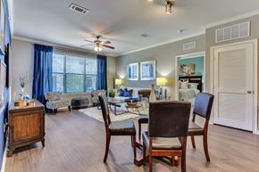 Mckinney apartment for rent - A dining room with a table set for two and a couch in the background.