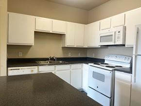 San Antonio apartment for rent - A kitchen with white appliances and cabinets.