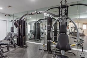 Wilmington apartment for rent - A gym with a variety of equipment including a leg press machine.