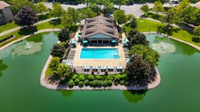 Arlington Heights apartment for rent - A large building with a pool in front of it.