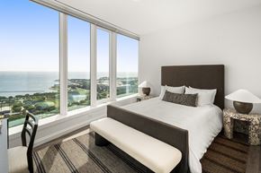 Chicago apartment for rent - A bedroom with a large bed and a view of the ocean.