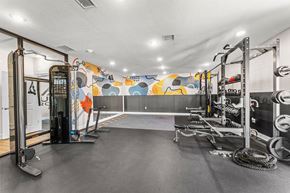 Kansas City apartment for rent - A gym with a variety of equipment including a squat rack, a bench, and a rope.