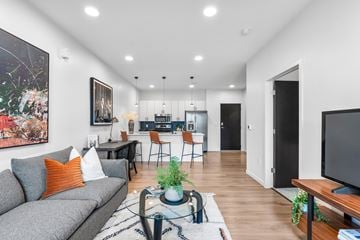 Kansas City apartment for rent - A modern living room with a grey sofa and a coffee table.