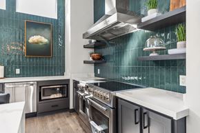 Lee's Summit apartment for rent - A modern kitchen with a stainless steel oven and a white countertop.