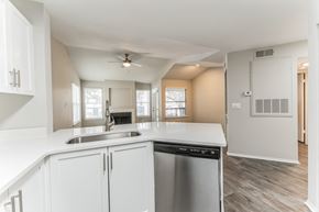 Orlando apartment for rent - A kitchen with white cabinets and a stainless steel dishwasher.