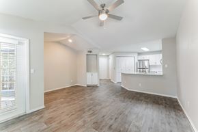 Orlando apartment for rent - A spacious room with a ceiling fan and wooden flooring.