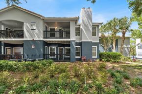 Orlando apartment for rent - A modern two-story building with a balcony on the second floor.