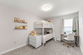 Bonner Springs apartment for rent - A white bunk bed with a desk and chair in a room.