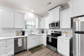 Bonner Springs apartment for rent - A white kitchen with a refrigerator on the right.