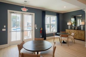 Ringgold apartment for rent - Clubhouse living room with additional table seating, looking onto the pool deck.