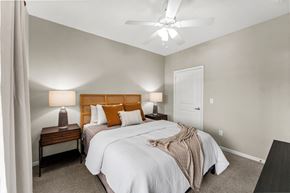 Kansas City apartment for rent - A bedroom with two beds and a ceiling fan.