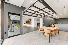 Kansas City apartment for rent - A modern dining room with a glass door leading to a balcony.