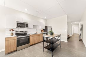 Kansas City apartment for rent - A kitchen with a black table and a stove with a pot on it.