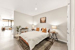 Kansas City apartment for rent - A bedroom with a large bed and a painting on the wall.