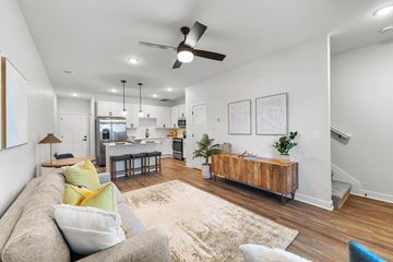 Raymore apartment for rent - A living room with a grey couch and a rug.
