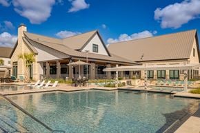 Austin apartment for rent - A large house with a pool in front.