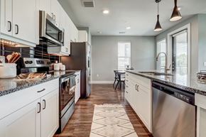Austin apartment for rent - an open kitchen with stainless steel appliances and granite counter tops