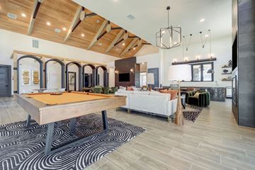 Austin apartment for rent - A modern living room with a pool table and a sofa.