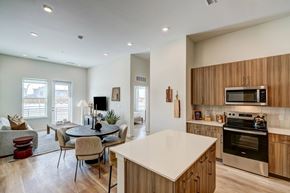 Aurora apartment for rent - A modern kitchen with wooden cabinets and stainless steel appliances.