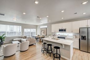 Aurora apartment for rent - A modern kitchen with white cabinets and stainless steel appliances.