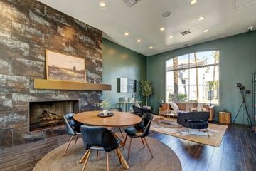 Phoenix apartment for rent - A living room with a fireplace and a painting on the wall.