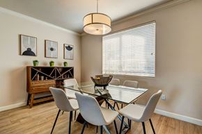 Phoenix apartment for rent - A dining room with a glass table and white chairs.
