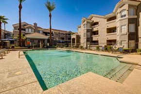 Phoenix apartment for rent - A large swimming pool in front of apartment buildings.