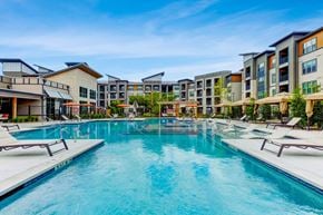 San Antonio apartment for rent - a swimming pool with an apartment building in the background
