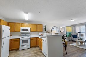 Anderson apartment for rent - A kitchen with wooden cabinets and white appliances.