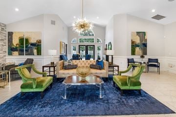 Anderson apartment for rent - A living room with a blue rug and green chairs.