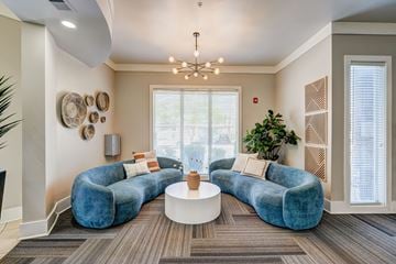 Peoria apartment for rent - A living room with a blue couch and a white coffee table.
