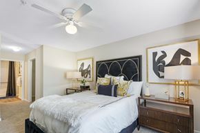 Anderson apartment for rent - A bedroom with a bed, nightstand, and artwork on the wall.