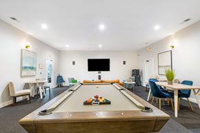 Anderson apartment for rent - A pool table is in the middle of a room with a TV and a dining table.