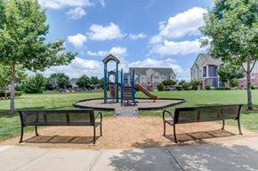 Fort Worth apartment for rent - A playground with a slide and two benches in the foreground.