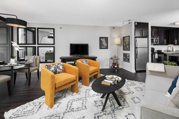 Chicago apartment for rent - A living room with a yellow chair and a black coffee table.